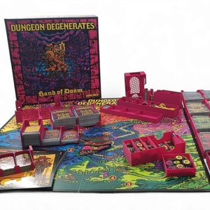 May include: A board game called "Dungeon Degenerates: Hand of Doom" with a fantasy theme. The game includes a board, cards, dice, and game pieces. The box art features a detailed illustration with the game's title and the words "Hand of Doom".
