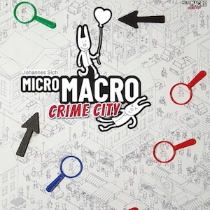 May include: A board game called "Micro Macro Crime City" featuring a black and white city scene. The image includes red, green, and blue magnifying glasses, black arrows, and cartoon characters. The game's logo is clearly visible.