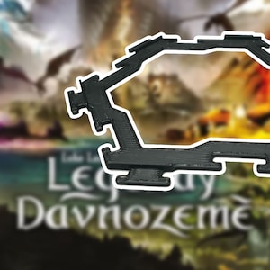 May include: A black, geometric game piece with a unique shape, possibly a component for a board game. The piece is made of a solid material and has a detailed, angular design. The background is a blurred image of a game box.