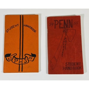 May include: Two vintage student handbooks. The orange one has "STUDENT HANDBOOK" and "PHS" with the years "53" and "54" on it. The red one has "54 PENN 55" and "STUDENT HANDBOOK" on it.