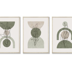 May include: Set of three framed prints with abstract geometric shapes in shades of green and beige, featuring a line drawing of a leafy branch in each print.