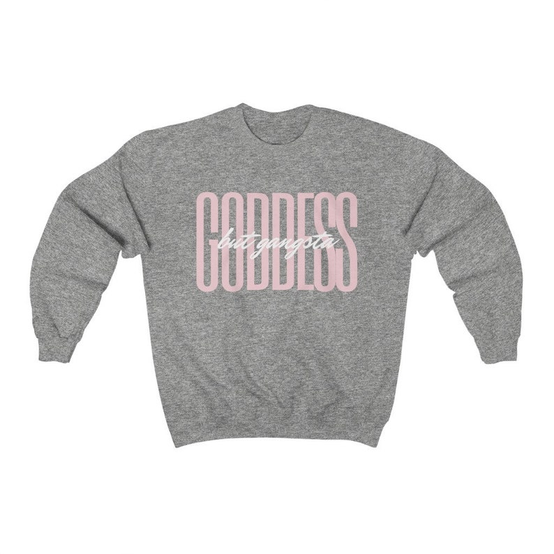 May include: A heather grey sweatshirt with the text "GODDESS but gangsta" printed in pink.
