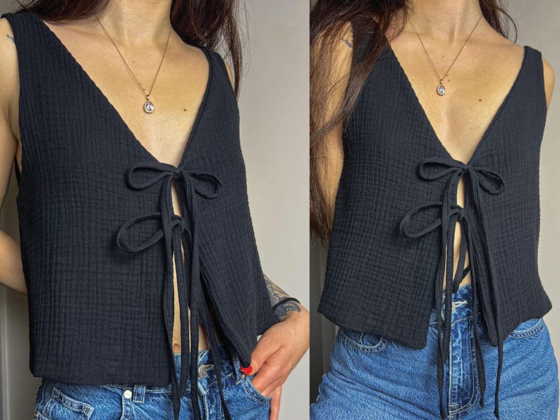 May include: A black sleeveless top with a tie-front detail. The top is made of a soft, textured fabric and has a relaxed fit.