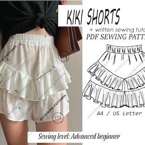 Op de afbeelding: Witte shorts met ruches en een bloemenpatroon. De shorts maken deel uit van een PDF-naaipatroon genaamd "KIKI SHORTS" met een geschreven tutorial. Het naainiveau is gevorderde beginner. Het patroon bevat A4, US Letter en A0 maten.