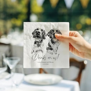 May include: A white square paper napkin featuring a black and white sketch of two dogs. The text reads "Drinks on us!" followed by "Love, Gunner and Moose" and the date "11.20.2026". The napkin has a textured border and a matte finish.