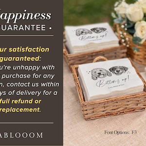 May include: White square paper napkins stacked in a woven wicker basket. The napkins feature a black ink illustration of two dogs, the text Bottoms up!, and the names Lou, Mabel & Fen printed in a script font. The design includes small hearts.