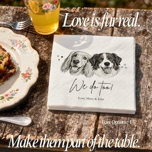 May include: A square white paper napkin featuring a black and white illustration of two dogs, with the printed text "Love is fur real.", "We do too!", and "Love, Mary & John". The napkin is textured and displays a detailed sketch of the dogs.