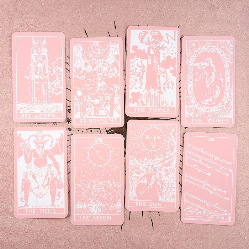 May include: A set of eight tarot cards with a pink background. Each card features white illustrations and text, including "Ace of Cups," "Judgement," "The Tower," "The World," "The Devil," "The Moon," and "The Sun."