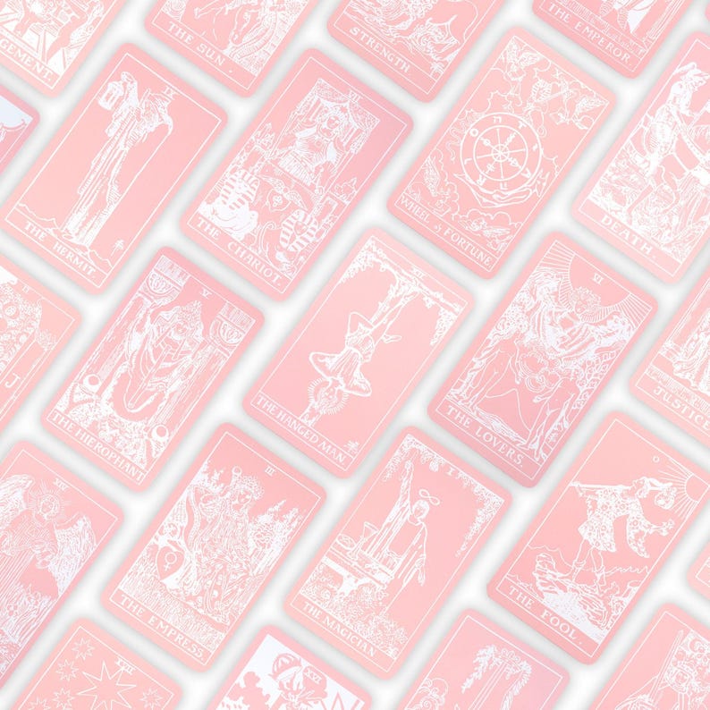 May include: A collection of pink tarot cards with white illustrations and text. The cards feature images of The Sun, The Hermit, The Chariot, The Hanged Man, The Lovers, and The Fool. The cards are arranged diagonally across a white background.