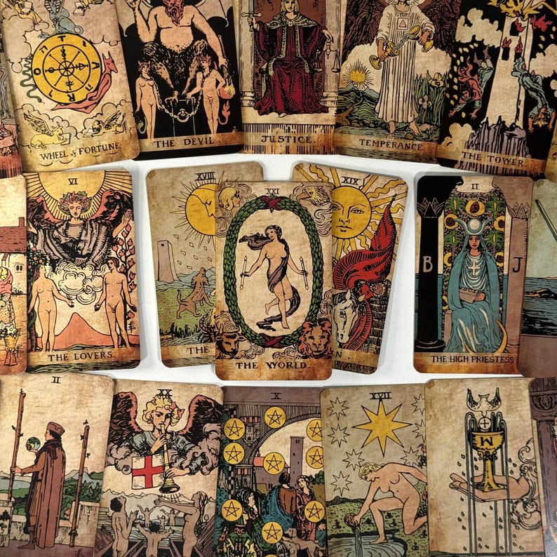 May include: A collection of vintage-style tarot cards, featuring illustrations and titles such as "Wheel of Fortune," "The Devil," and "The Lovers." The cards have a distressed, aged appearance with detailed artwork and symbolic imagery.