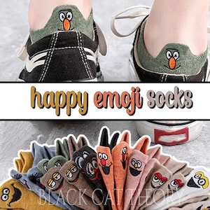 May include: A collection of colorful socks with happy emoji faces. The socks are made of soft, comfortable material and feature a variety of designs, including a smiling face, a winking face, and a heart-shaped face. The socks are perfect for adding a touch of fun to any outfit.