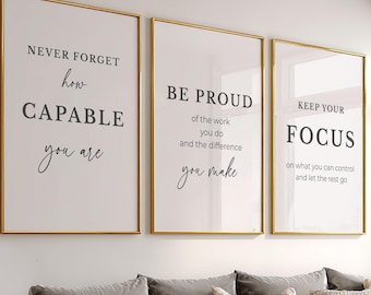 May include: Three vertical wall art prints in thin gold frames. The first reads: NEVER FORGET how CAPABLE you are. The second: BE PROUD of the work you do and the difference you make. The third: KEEP YOUR FOCUS on what you can control and let the rest go.