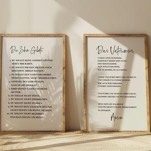 May include: Two framed prints with text in German. The left print says "The Ten Commandments" and the right print says "The Lord's Prayer". Both prints have a light background and a wooden frame. The text is in black.