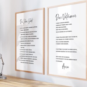 May include: Two framed prints with light wood frames. The left print features the text "Die Zehn Gebote" in black, with a list of commandments below. The right print displays "Das Vaterunser" in black script, with a prayer below.
