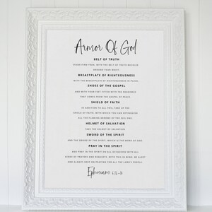 May include: A white framed print with black text outlining the Armour of God, a Christian concept. The text includes the Bible verse Ephesians 6:14-18.