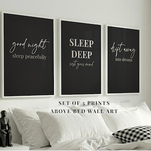 May include: Set of three framed prints with black backgrounds and white text. The prints read "good night sleep peacefully", "SLEEP DEEP rest your mind", and "drift away into dreams". The text "SET OF 3 PRINTS ABOVE BED WALL ART" is below the prints.