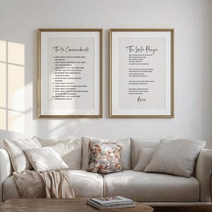 May include: Two framed prints with gold frames hang above a beige sofa. The left print displays "The Ten Commandments" in black script, while the right print features "The Lord's Prayer." The prints add a touch of spirituality to the living room.