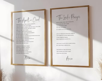 May include: Two framed prints with gold-colored frames. The left print displays "The Apostles' Creed" and the right print displays "The Lord's Prayer" in elegant script. Both prints feature black text on a white background.