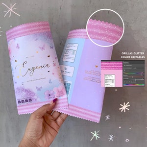 May include: Pink and purple party favour bags with glitter edges. The bags feature a butterfly design and the text "Eugenia" in gold lettering. The bags are decorated with a pink and white striped pattern.