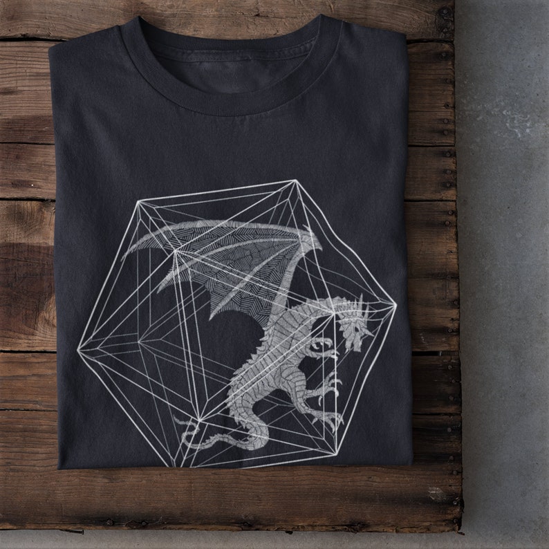 May include: A dark gray t-shirt with a white geometric design of a dragon inside a cube.