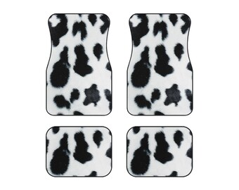 May include: Set of four black and white cow print car floor mats. Two larger mats are for the front seats and two smaller mats are for the back seats.