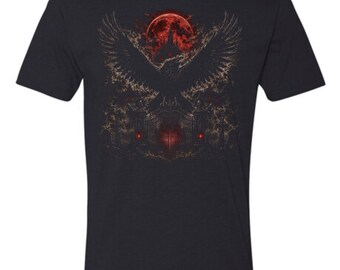 May include: A black short-sleeve t-shirt featuring a graphic print of a large raven with spread wings flying above a dark, ornate iron gate. A glowing red full moon hangs in the background, casting a crimson light over the scene below.