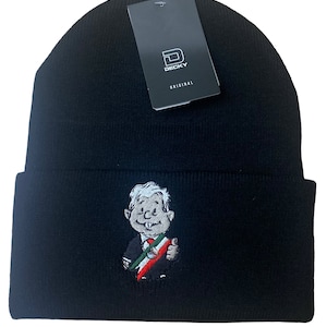 May include: Black beanie with a white embroidered cartoon character wearing a green, white, and red scarf. The beanie has a black tag with the text "DECKY ORIGINAL" on it.