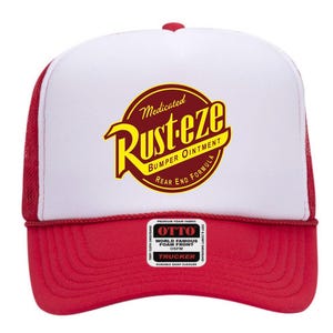 May include: A red and white trucker hat featuring a circular logo that reads Medicated Rust-eze Bumper Ointment Rear End Formula in yellow and dark red. The cap has a white foam front panel, a red brim, and a small rectangular Otto brand label.