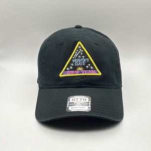 May include: Black dad hat with a yellow triangle patch that says "Heaven's Gate Away Team" in colorful embroidered lettering.