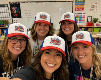 May include: A white, red, and blue trucker hat featuring a graphic design on the front panel with the text "TEACHING IS MY THING" in colorful, stylized lettering surrounded by paint splatter motifs and small school-related icons.