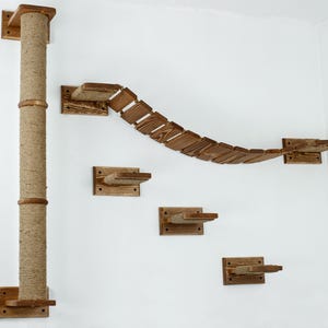 May include: A wooden cat tree with a scratching post and multiple platforms. The platforms are connected by a curved bridge made of wooden slats.