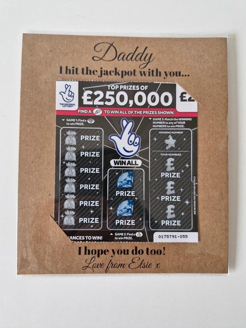 May include: A greeting card with a lottery ticket design. The card is brown with the words "Daddy, I hit the jackpot with you..." printed on it. The lottery ticket shows prizes and the text "I hope you do too! Love from Elsie x."