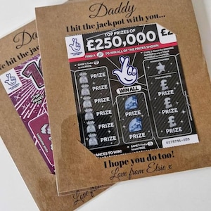 May include: Two brown paper cards with lottery tickets. One ticket shows a top prize of &pound;250,000. Text on the cards reads "Daddy, I hit the jackpot with you..." and "I hope you do too! Love from Elsie x."