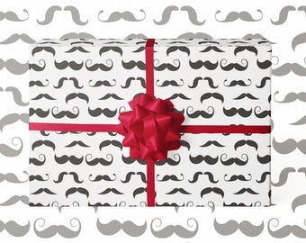 May include: A wrapped gift with white paper covered in black mustache patterns. A red ribbon and bow are tied around the gift. The background is white with a pattern of gray mustaches.