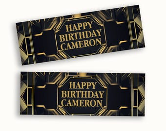 May include: Two rectangular banners featuring a black background with gold geometric lines and accents. The text "HAPPY BIRTHDAY CAMERON" is printed in gold capital letters in the center of each banner, framed by an octagonal border.