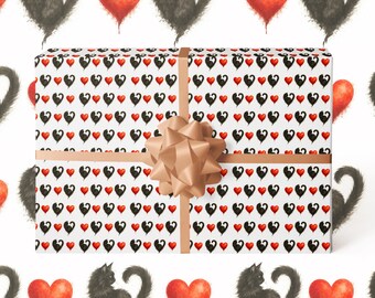 May include: A wrapped gift with a white background featuring a pattern of black cat silhouettes and red hearts. The gift is wrapped in patterned paper and tied with a tan ribbon and bow. The overall theme is love and cats.