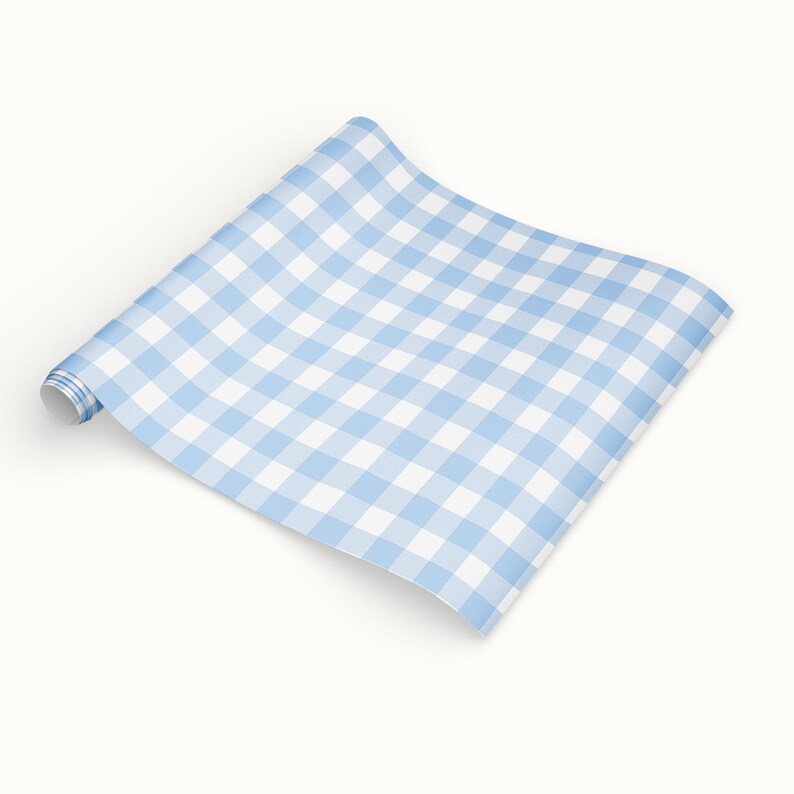May include: A roll of light blue and white gingham patterned paper. The paper is unrolled, revealing the classic checkered design. The paper is ideal for crafts, wrapping, or decorative purposes.