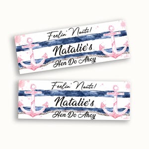 May include: Two rectangular nautical banners featuring pink anchors, blue and white stripes, and the text "Feelin' Nauti! Natalie's Hen Do Ahoy". The design has a watercolor effect.