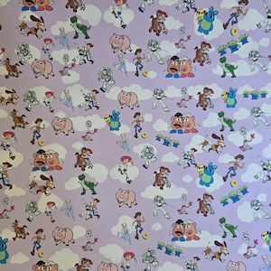 May include: A light purple background with a repeating pattern of characters from the animated film Toy Story. The pattern includes characters such as Woody, Buzz Lightyear, Mr. Potato Head, and others, along with white cloud shapes.