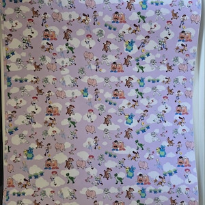 May include: Wallpaper featuring a repeating pattern of characters from the animated film Toy Story. The design includes Woody, Buzz Lightyear, Rex, Hamm, Mr. Potato Head, and other characters, set against a light purple background with white cloud accents.