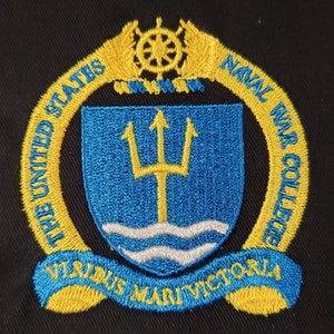May include: A gold embroidered patch with a blue shield featuring a yellow trident and a white wave. The shield is surrounded by a gold wreath with the text "The United States Naval War College Virtus Mari Victrix".