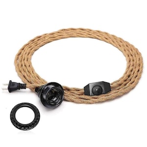 May include: A brown braided electrical cord with a black plug, lamp socket, and on/off switch. A black ring is also included. The cord is coiled and ready for use. The components are set against a white background.