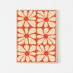 May include: A framed print with a repeating pattern of stylized cream-colored flowers on an orange background.