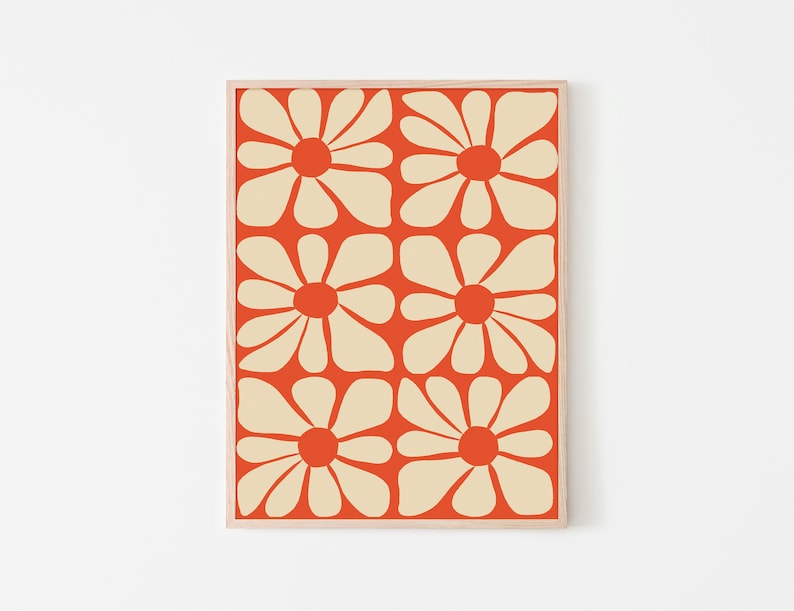 May include: A framed print with a repeating pattern of stylized cream-colored flowers on an orange background.