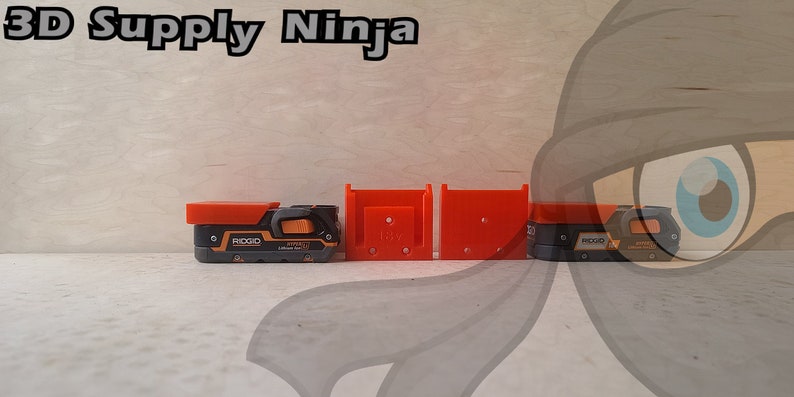 May include: Three 3D printed orange and black tool holders for a Ridgid power tool. The holders are designed to be mounted on a wall or shelf.