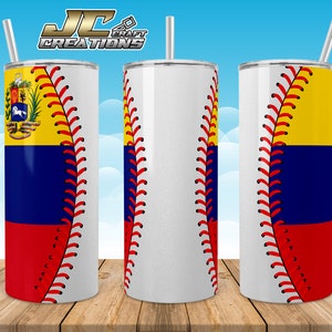 May include: A white stainless steel tumbler with a baseball stitch design and the flag of Ecuador on the side. The tumbler is on a wooden surface.