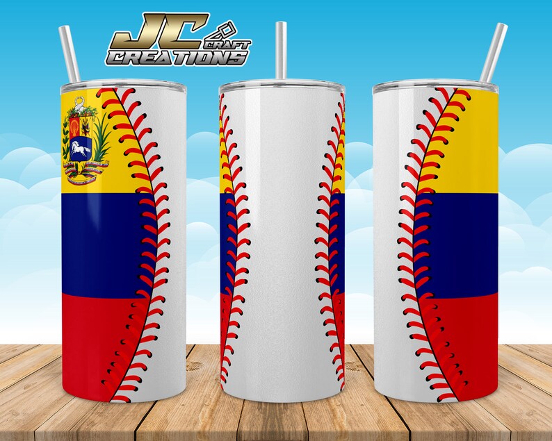May include: A white stainless steel tumbler with a baseball stitch design and the flag of Ecuador on the side. The tumbler is on a wooden surface.