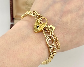 Pulsera vintage Pierre Cardin de oro de los años 70 con candado y corazón, cadena trenzada de diseñador con eslabones llamativos.