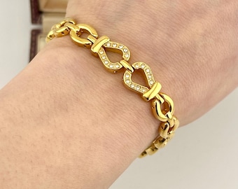Pulseira vintage com painel em formato de freio de cavalo, corrente dourada estilo equestre dos anos 80, joia com elos inspirada em designers renomados.