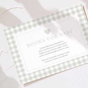 May include: A baby shower card with a light green gingham pattern border. The card reads "BOOKS FOR BABY" with a heart graphic. Text below encourages guests to sign their name and leave a message.